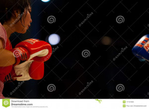 BANGKOK - OCTOBER 12: A female muay thai kickboxer faces off with a ...