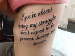 cursive text tattoo on rib 4