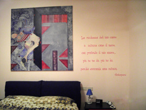 An Italian Shakespeare wall quote on the bedroom with the bed and the ...