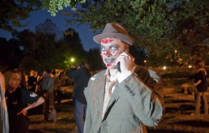 Zombie makes a phone call before the fourth annual Lawrence Zombie