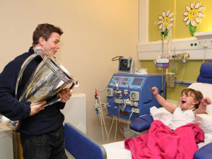 Irish rugby player Brian O’Driscoll visits a young girl in the ...