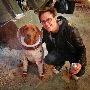 Fred the dog in costume with James Gunn.