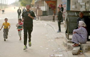 Palestinian Olympic runner Nader Al Masri runs near his house in Beit