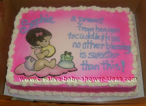 pink baby shower cake with picture of baby sitting on a blanket next ...