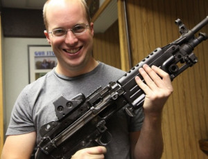 What make and model of firearm is Paul Buchheit holding in his ...