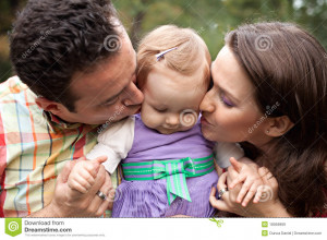 Royalty Free Stock Images: Kiss of love - parents with their baby girl