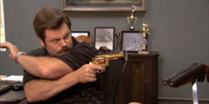 Ron Swanson aiming his gold plated pistol.