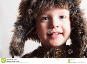 Funny smiling child in a fur hat. fashion kid. winter style. little ...