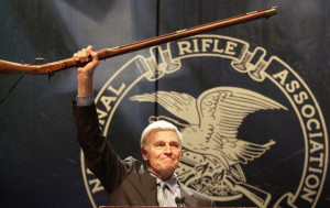 NRA President Charlton Heston holds up a musket as he tells the 5,000 ...