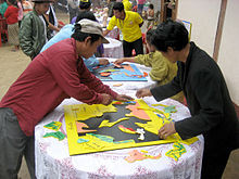 Lao villagers assemble jigsaw maps of Southeast Asia. These maps were ...