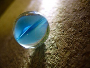 blue cat's eye marble on a cork background Stock Photo
