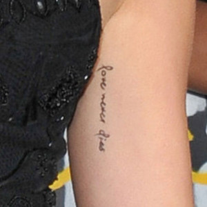 Miley Cyrus love tattoo on left arm