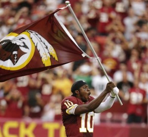 Washington Redskins' Griffin III waves the team banner before playing ...