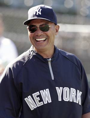 to the New York Yankees' Reggie Jackson smiles before a baseball ...