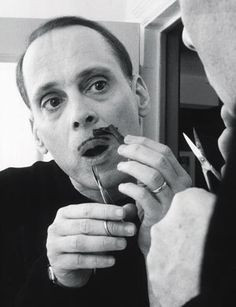 John Waters grooming his famous mustache More
