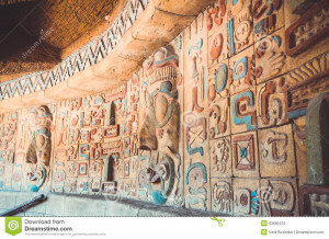 Ruins of ancient color art wall of the Aztecs. Stone carving with a ...