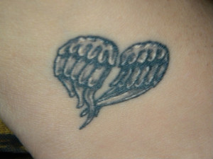 Wings in heart shape tattoo