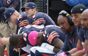 Jay Cutler (6) and his teammates watch from the bench in the third ...