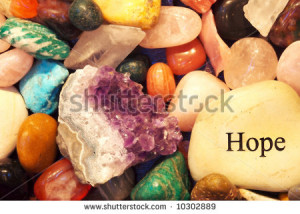 Healing stones and crystals with a rock with the word hope on it