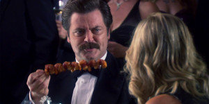 Ron Swanson with his masterpiece skewer of bacon wrapped shrimp