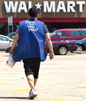 female Wal-Mart employee walks through a parking lot as she returns ...
