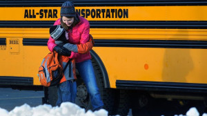 PHOTO: A woman hugs a child before he boards a bus on the first day of ...