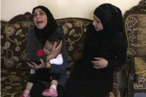 The widow of Lebanese soldier Ali al-Sayyed clutches her daughter as ...