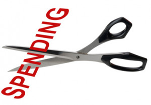 Pair of scrissors cutting the word Spending