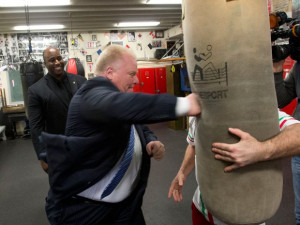 Mayor Rob Ford punches a heavy bag in a boxing gym at the Cabbage Town ...