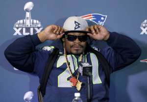 Seattle Seahawks' Marshawn Lynch adjusts his cap during an interview ...