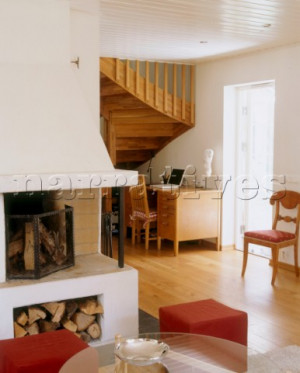 Sitting room with a inbuilt corner fireplace and a wooden staircase in ...