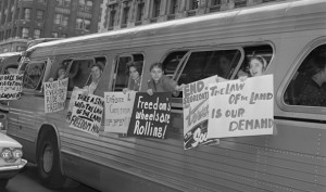 Freedom Riders hang posters from a bus during nonviolent civil rights ...