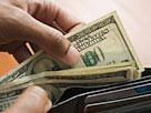 Image: Man taking money out of wallet (© Jose Luis Pelaez Inc/Blend ...