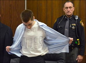Lane unbuttons his shirt during sentencing Tuesday, March 19 ...