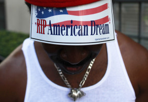 member of the Occupy Wall Street movement shows his sign as he ...