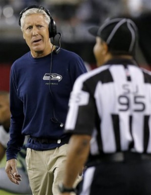 Seattle Seahawks coach Pete Carroll looks at side judge James Coleman ...