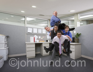 funny picture of a businessman with other business people riding him
