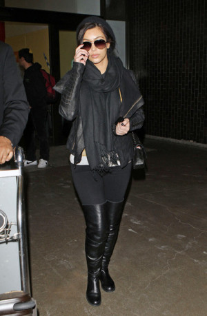 Going a little more low-key than on her last trip to the airport , Kim ...