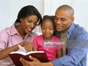 Royalty-free Image: parents and their daughter reading the bible