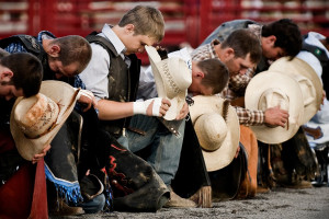 Riders bow for the traditional Cowboy Prayer before starting their ...