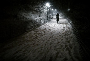 ... -up pedestrian walks along a snowy path in Central Park Friday night