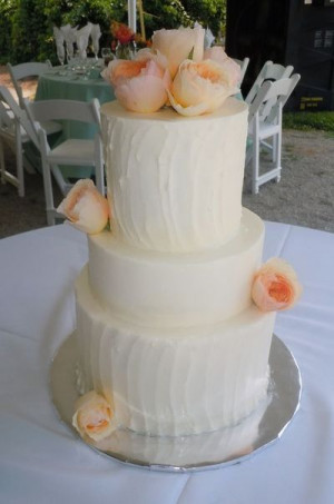 Contrasting rough and smooth iced buttercream wedding cake