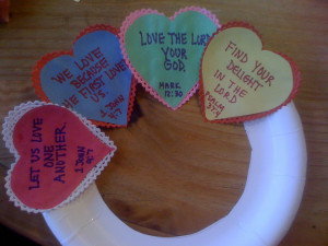 Once I wrote scripture verses on paper hearts, I glued them on paper ...