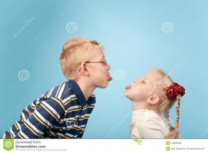 Royalty Free Stock Image: Boy and girl stick out tongues to each other
