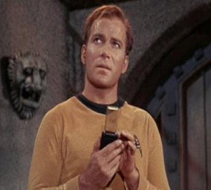 Captain Kirk using his tricorder in the TV series Star Trek