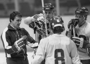 coach of the U.S. Olympic hockey team, chats with members of his team ...