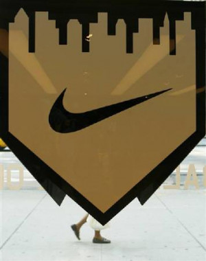 pedestrian walks past the Nike logo for the Major League Baseball ...