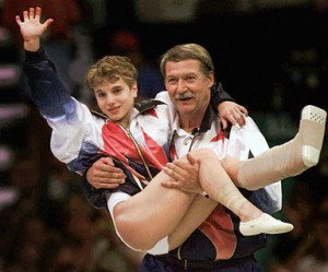 Kerri Strug being carried to the podium by her coach, Bela Karolyi ...