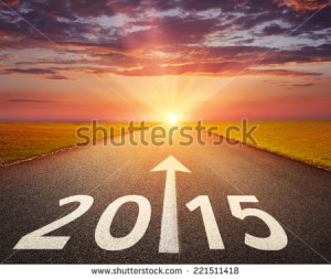 Driving on an empty road at sunset to upcoming 2015 - stock photo