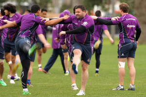 George Rose George Rose stretches with team mates during a Melbourne
